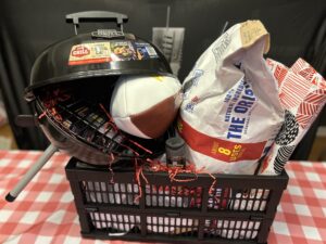 Packer's Grill Raffle Basket #9 - travel grill, bag of charcoal, Packer's football, BBQ tool set (tongs, spatula, fork), tablecloth, solar powered multifunctional lamp